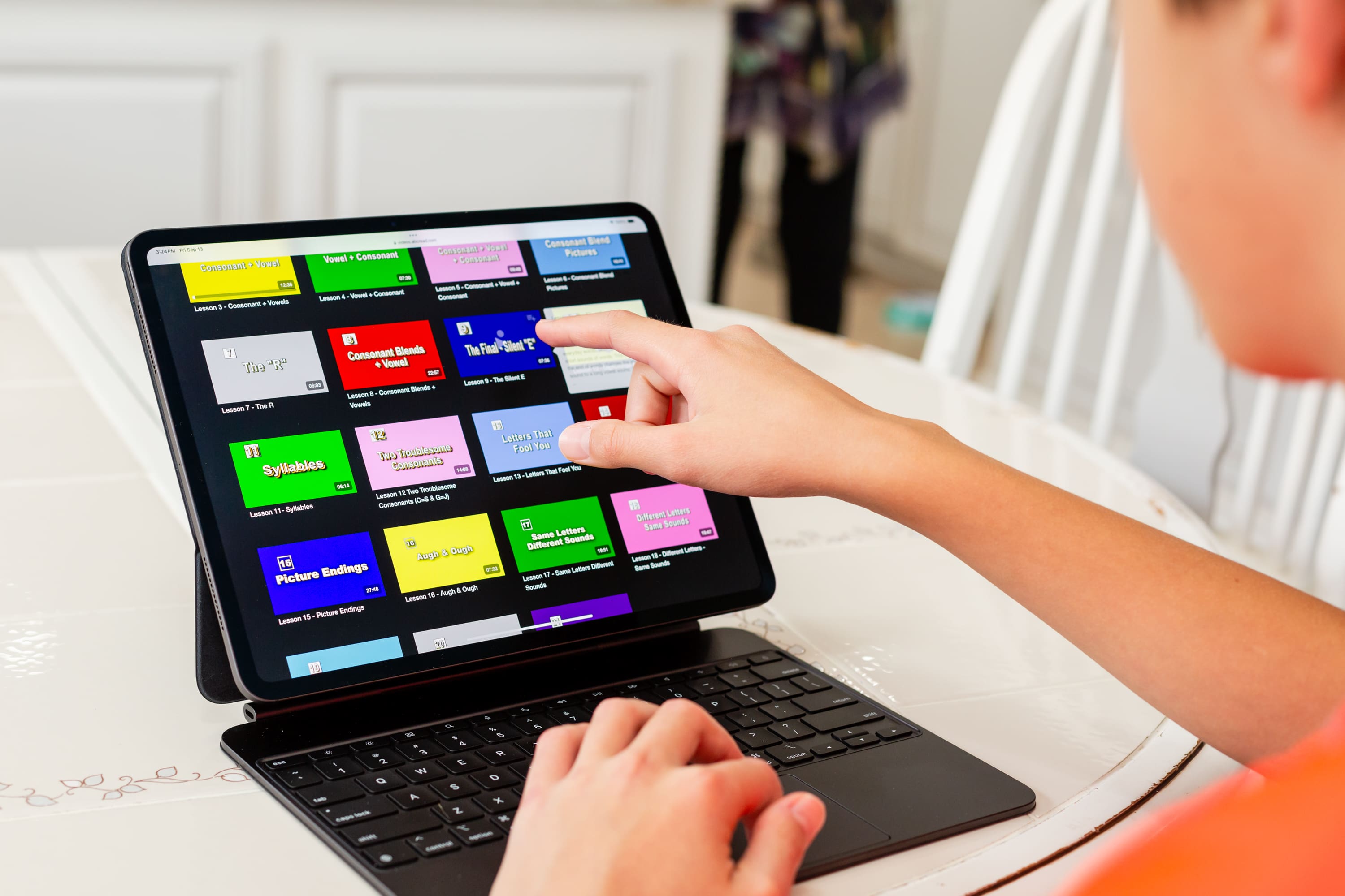 A person using a laptop on top of a table.